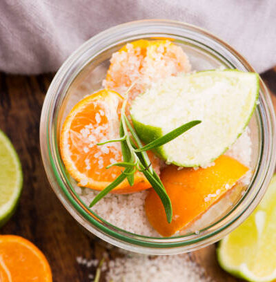 Preserved lime and mandarin with salt on a wooden board