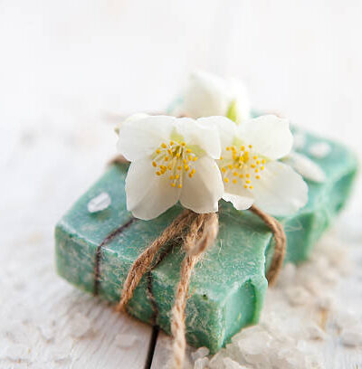 Spa setting with jasmine blossom, natural handmade soap and sea salt