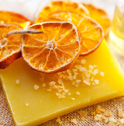 Orange soap and salt on wooden board