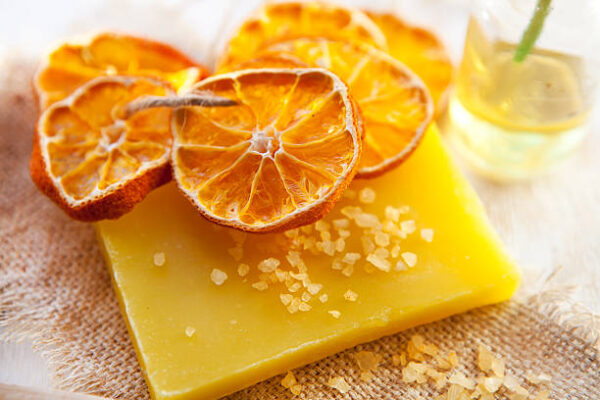 Orange soap and salt on wooden board